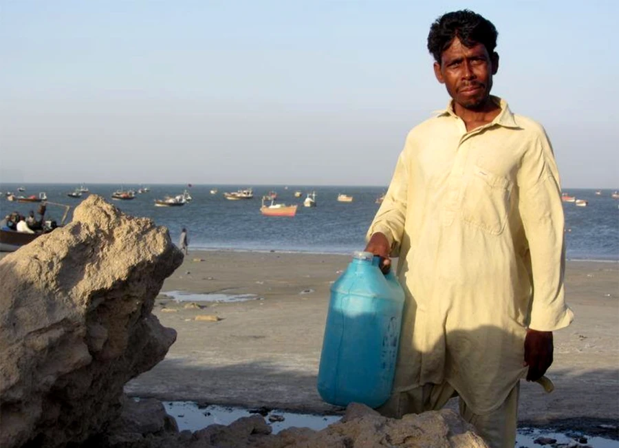 A fisherman holds a jerry can of drinking water near Pakistan's Arabian Sea port of Gwadar, on April 1, 2018. (Reuters/File)