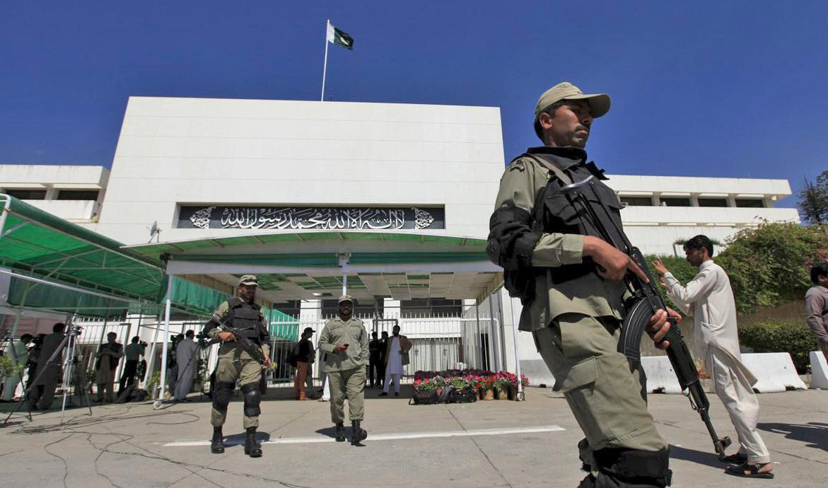 In this file photo, Paramilitary soldiers walk past the Parliament building during a joint sitting of the parliament in Islamabad April 10, 2015. (REUTERS)