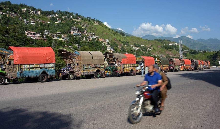 In this photo, Pakistani trucks are queued up at India-Pakistan Kashmir border. (Photo Courtesy: AFP)
