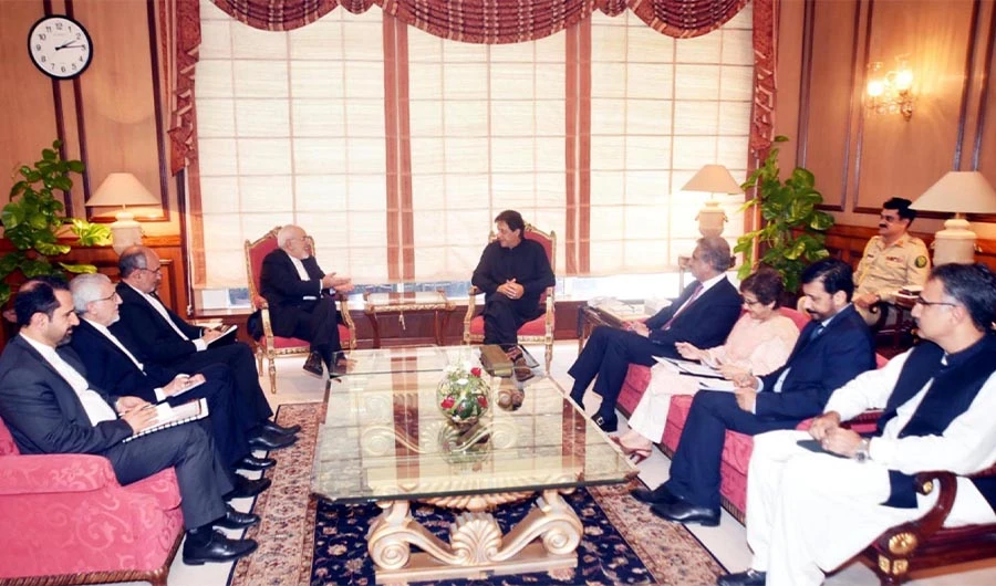In this file photo from August 31, 2018, Iranian Foreign Minister Javad Zarif can be seen in conversation with Prime Minister Imran Khan at his office in Islamabad. – (PID)