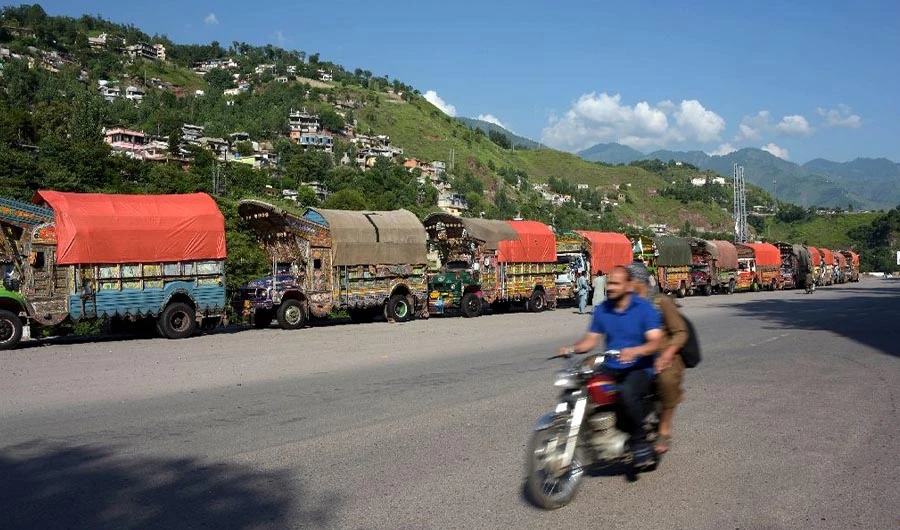 In this photo, Pakistani trucks are queued up at India-Pakistan Kashmir border. (Photo Courtesy: AFP)