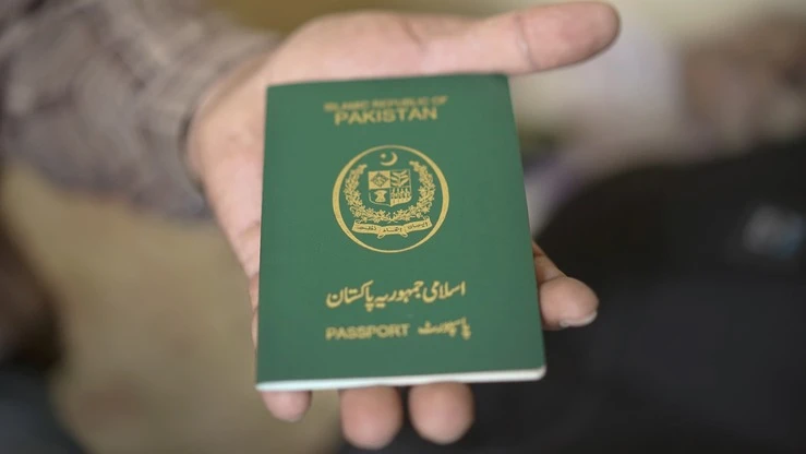 In this file photo, a man is holding a Pakistani passport. (AFP/file)