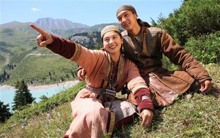 Legendary Kazakh hero Sartay (R) (Asylkhan Tolepov) sits with his beloved Zere (Aliya Telebarisova) near the Big Almaty Lake in the Tian Shan Mountains where the film Myn Bala was shot in June 2011. (Handout photo provided by Reuters)