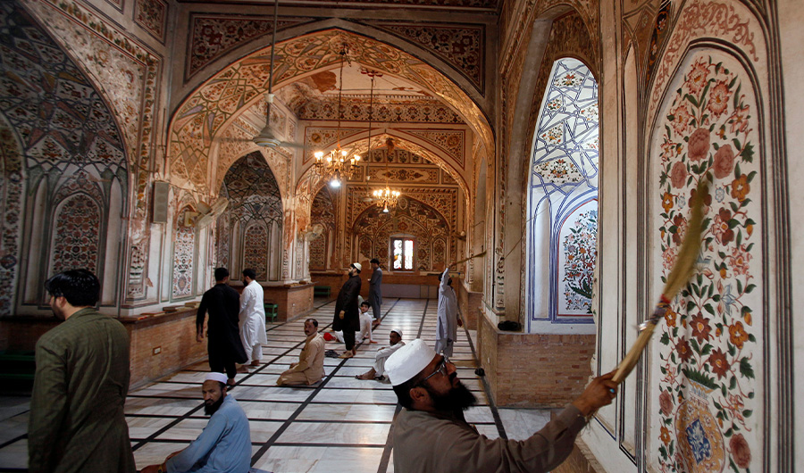 Pakistani men clean the walls while others offer noon prayers at a mosque ahead of the Muslim fasting month of Ramadan in Peshawar, Sunday, May 5, 2019. Muslims across the world will be observing the Ramadan, when they refrain from eating, drinking and smoking from dawn to dusk. (AP)