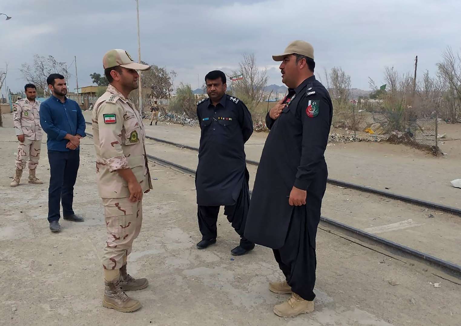 In this photo taken on October 16, 2018, a Pakistani border security official (R) and an Iranian border official meet at Zero Point in the Pakistan-Iran border town of Taftan. (AFP/FILE)