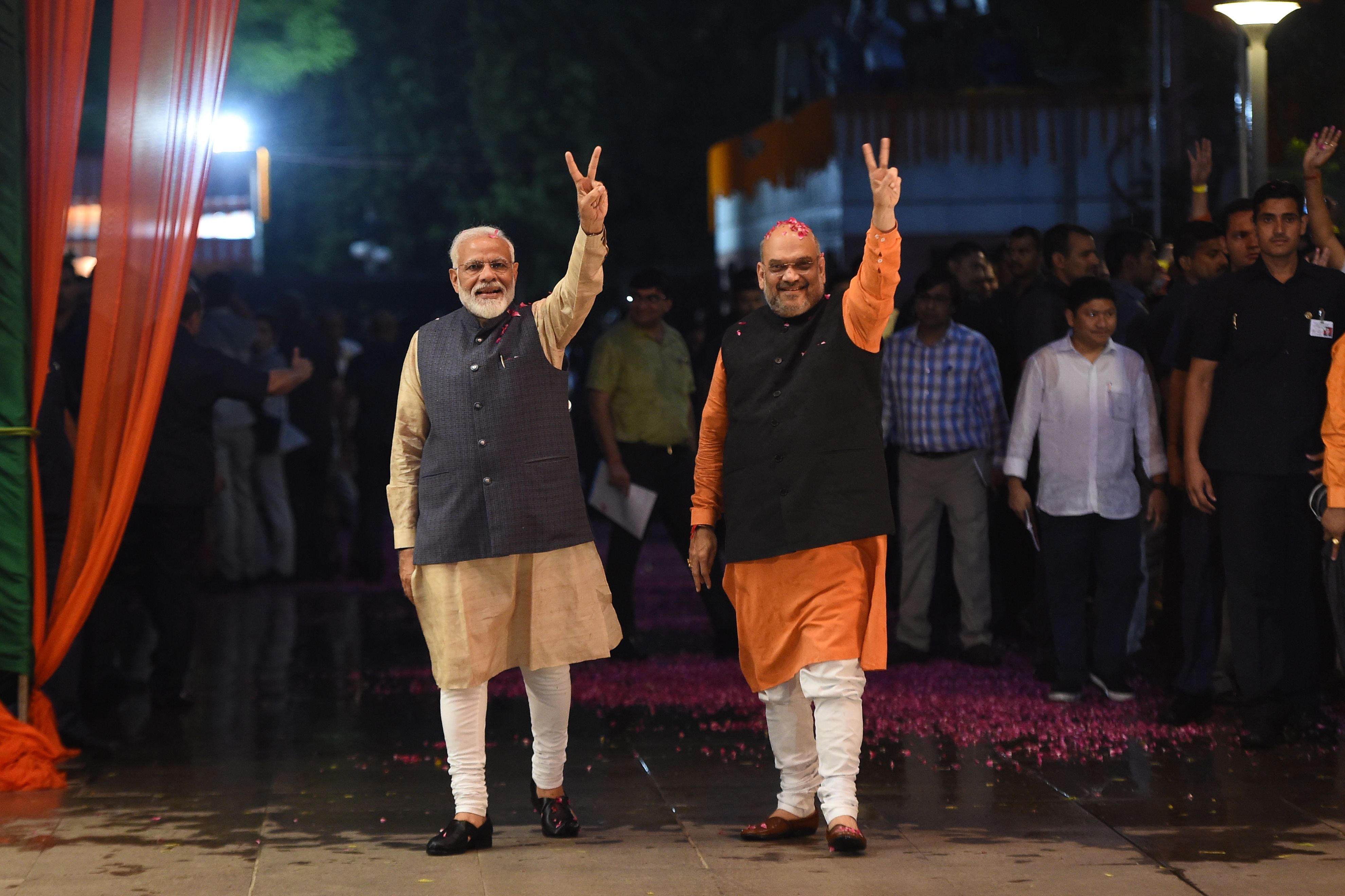 Indian Prime Minister Narendra Modi (L) and president of the ruling Bharatiya Janata Party (BJP) Amit Shah gesture as they celebrate the victory in India's general elections, in New Delhi on May 23, 2019. Hindu nationalist Prime Minister Narendra Modi claimed victory on May 23 in India's general election and vowed an "inclusive" future, with his party headed for a landslide win to crush the Gandhi dynasty's comeback hopes. (AFP)