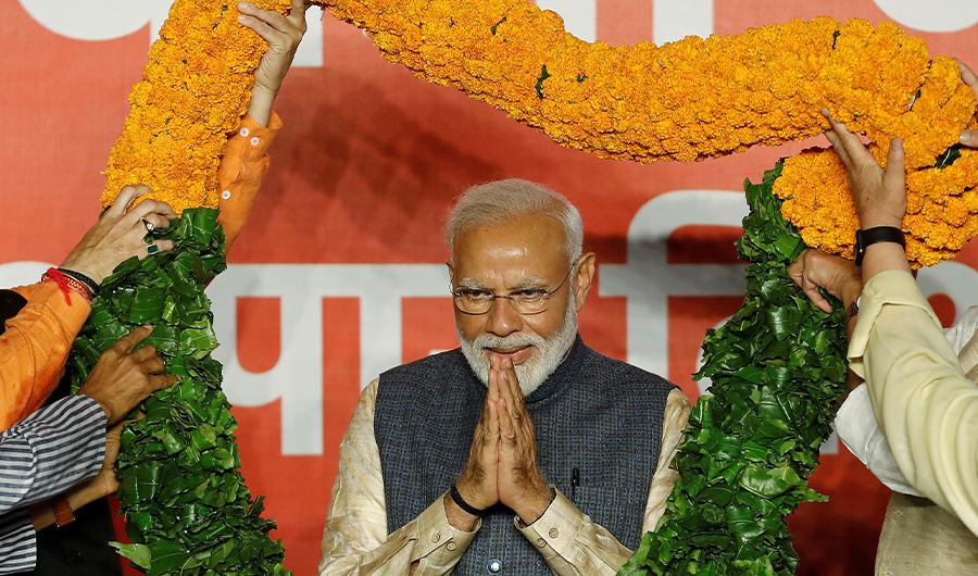 Indian Prime Minister Narendra Modi gestures as he is presented with a garland by Bharatiya Janata Party (BJP) leaders after winning a general election on May 23, 2019 - Reuters
