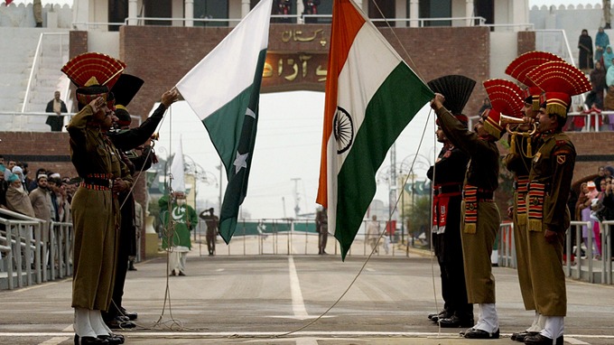 In this undated file photo, Indian and Pakistani soldiers lower their respective national flags at the Wagah border ceremony. (Reuters)