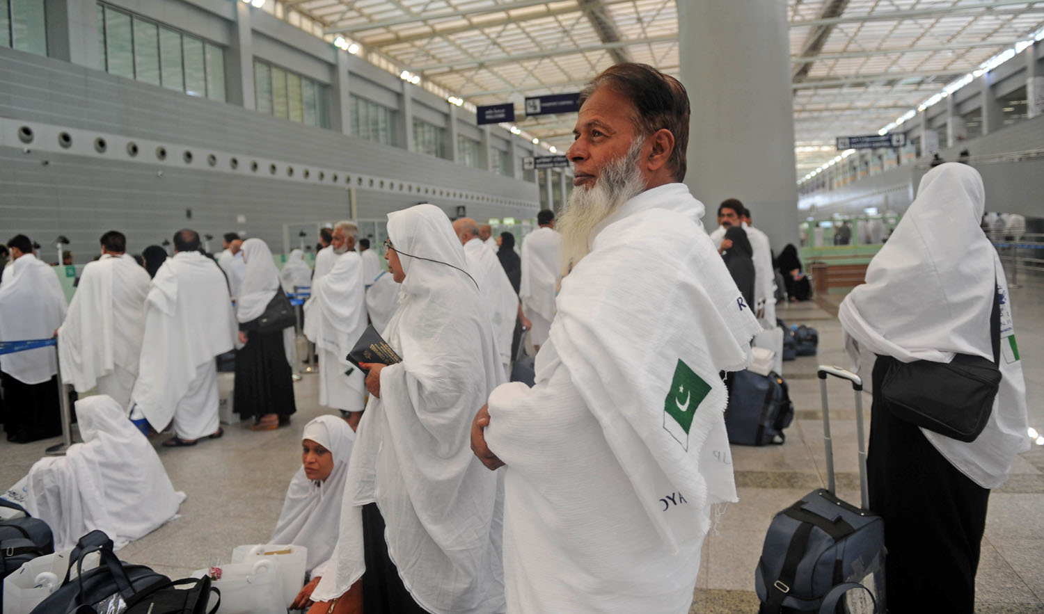 Pakistani pilgrims wait to pass security as the first group arrives in Jeddah on Monday. (AFP/File)