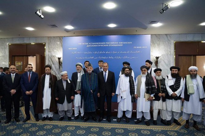 Russian Foreign Minister Sergei Lavrov (C-right) and former Afghan President Hamid Karzai (C-left) posing for a family photo together with the participants of a conference marking a century of diplomatic relations between Afghanistan and Russia. Senior Taliban officials including the group's top political advisor met with Afghan political figures in Moscow today, saying they were committed to peace in Afghanistan. (Russian Ministry of Foreign Affairs / AFP)