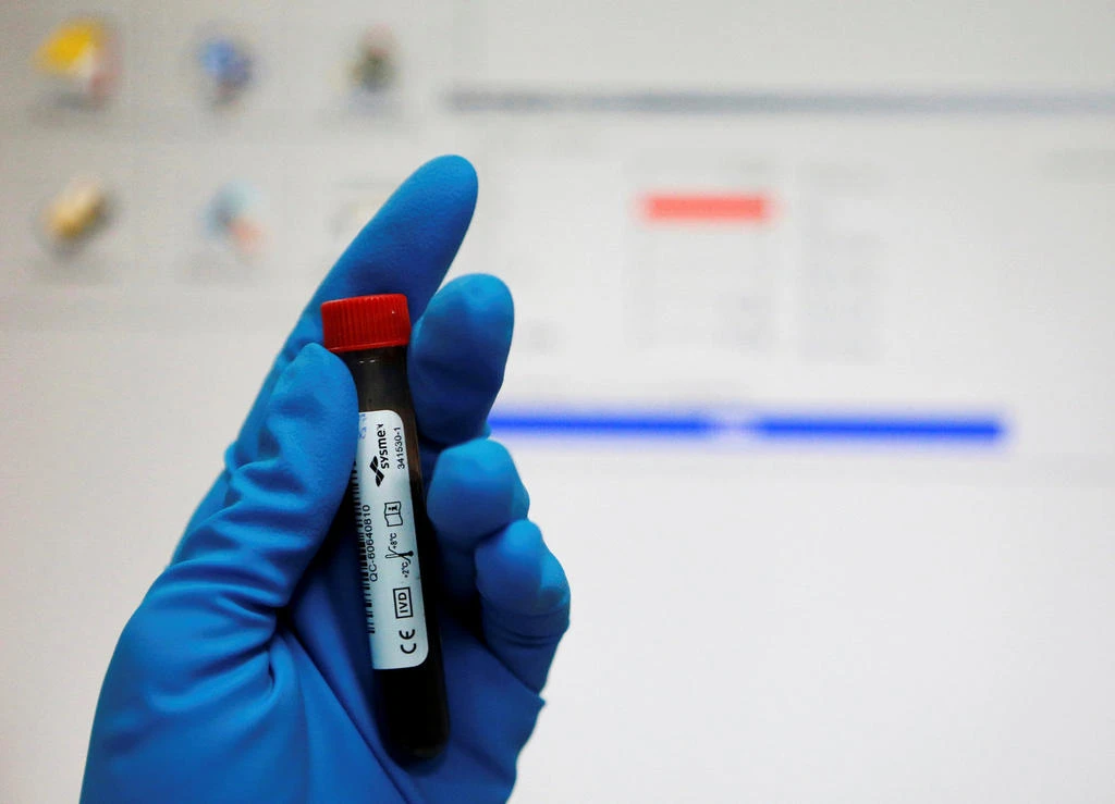 In this file photo a technician holds a test tube with a blood sample at anti-doping laboratory. (REUTERS / FILE)