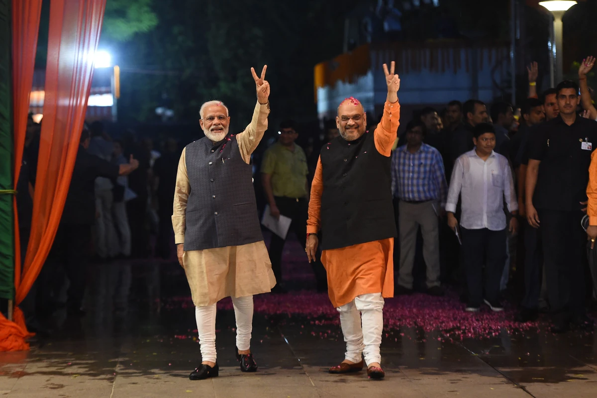 Indian Prime Minister Narendra Modi (L) and president of the ruling Bharatiya Janata Party (BJP) Amit Shah gesture as they celebrate the victory in India's general elections, in New Delhi on May 23, 2019. Hindu nationalist Prime Minister Narendra Modi claimed victory on May 23 in India's general election and vowed an "inclusive" future, with his party headed for a landslide win to crush the Gandhi dynasty's comeback hopes. (AFP)