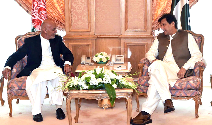 Pakistani Prime Minister Imran Khan meets Afghan President Ashraf Ghani on the sidelines of the 14th Organization of Islamic Cooperation summit in Makkah, Saudi Arabia, on Friday, May 31, 2019. (AFP)