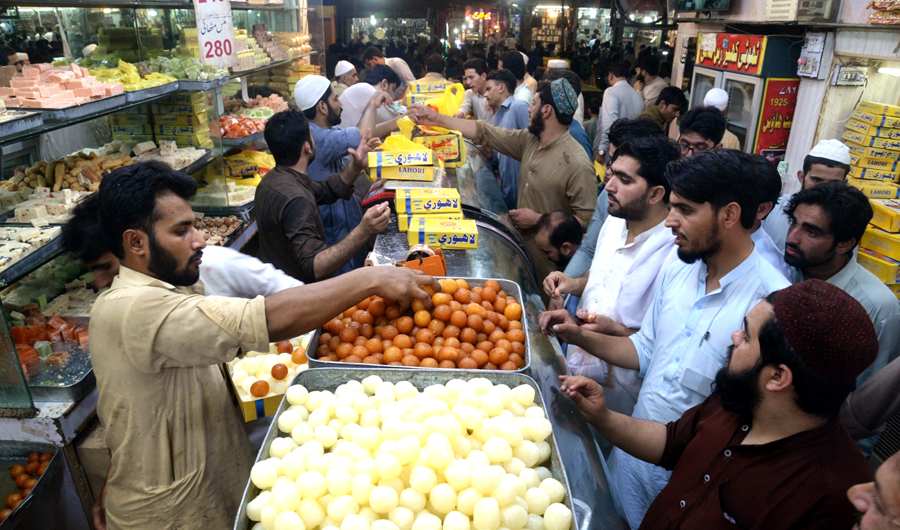 People buy sweets in Pakistan's Peshawar, Jun 16, 2018. (Image credit: IANS)