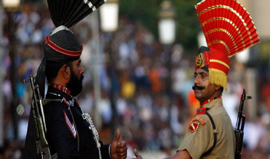 A Pakistani Ranger (L) and an Indian Border Security Force (BSF) soldier gesture to each other during the daily parade at the Pakistan-India joint check-post at Wagah border, on the outskirts of Lahore. (Reuters/File Photo)