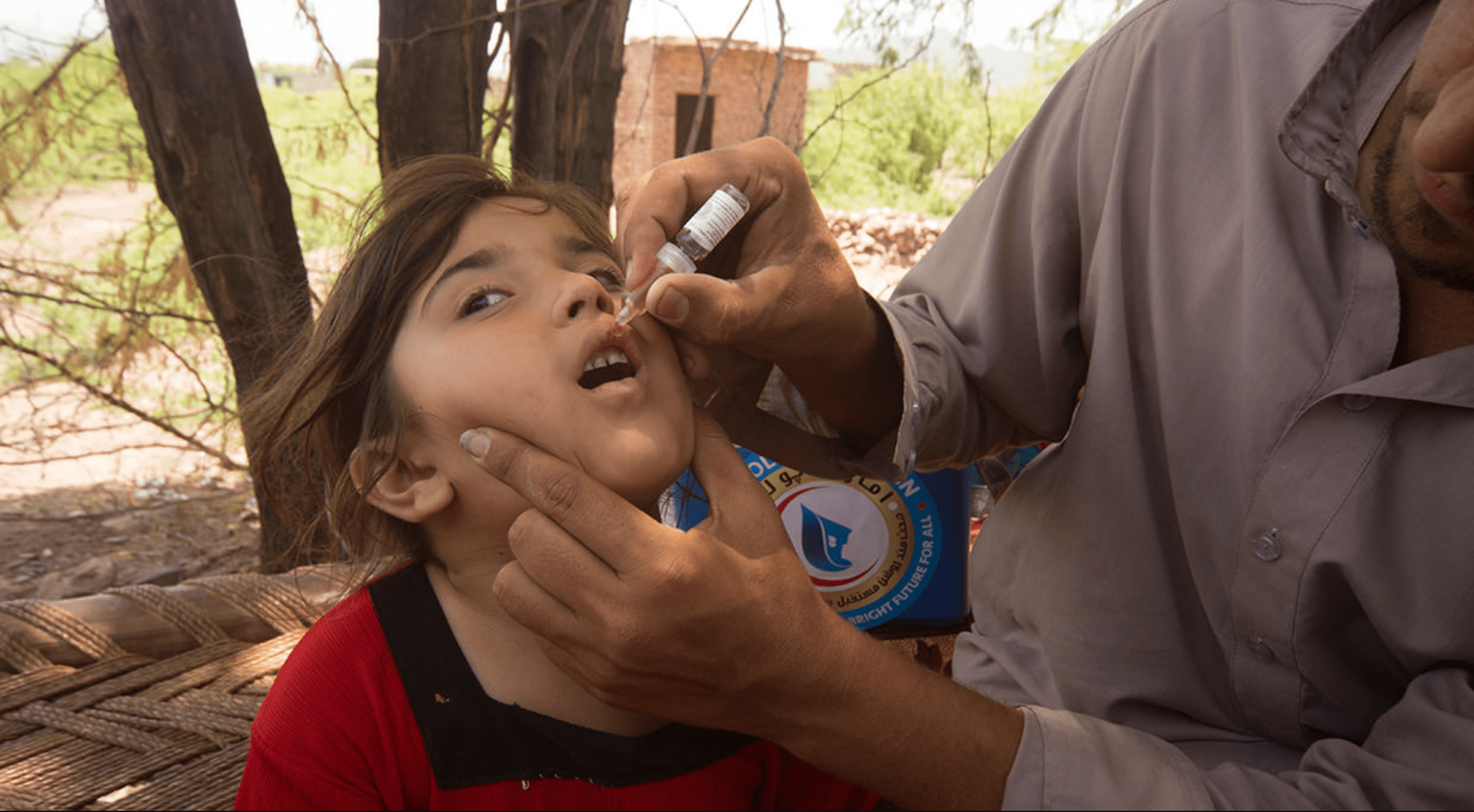 A Pakistani health worker administers polio vaccine drops to a child as a part of UAE’s polio vaccination campaign. More than 407 million drops of polio vaccine were administered to children under the age of five in Pakistan between 2014 and April 2019. (Photo courtesy : UAE Vaccination Campaign against Polio)