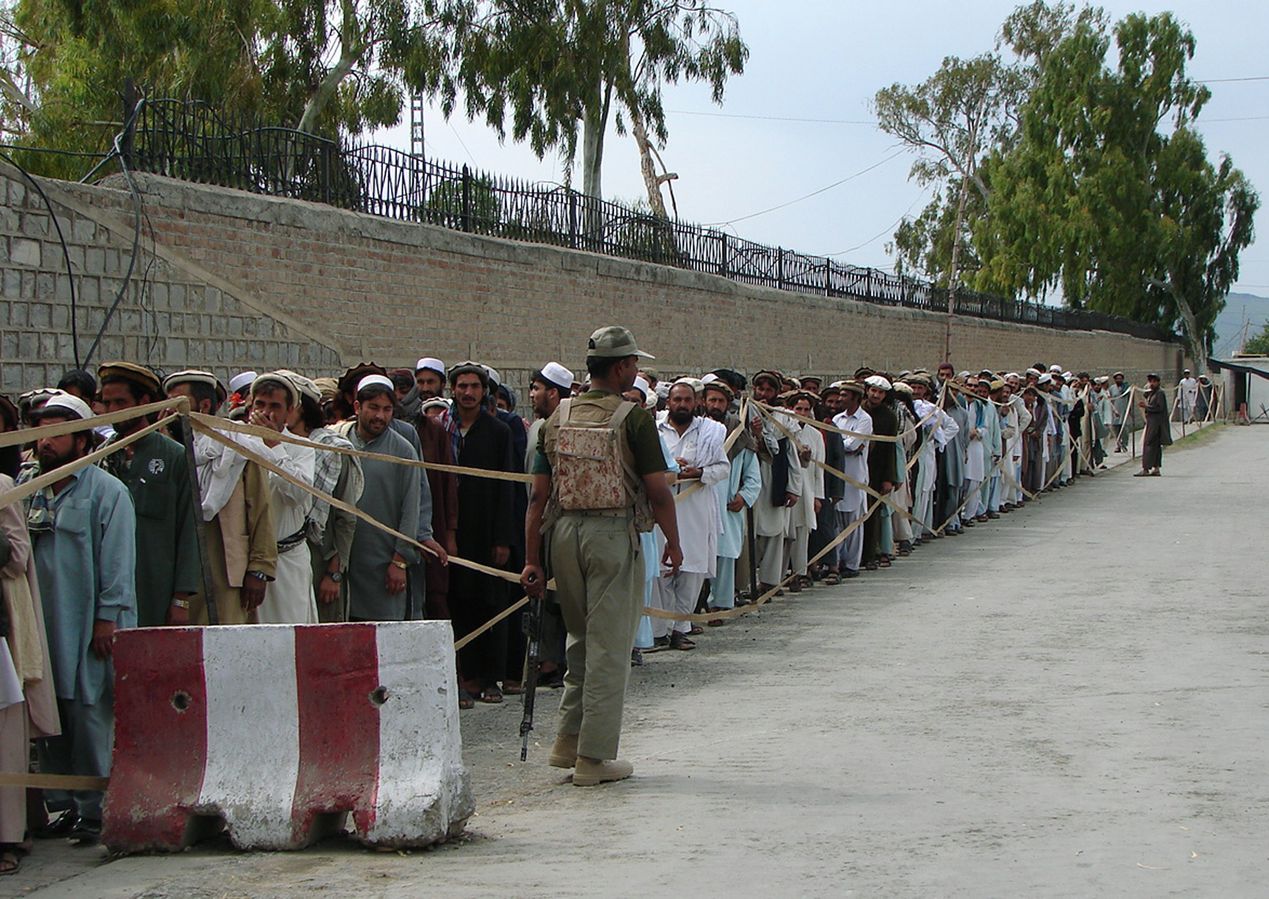 In this file photo, Pakistan’s tribal voters stand in a queue as they wait for their turn to cast their votes outside a polling station in restive Miranshah, the main town of North Waziristan on May 11, 2013. (AFP / file)