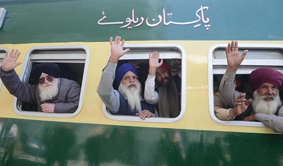 In this file photo, Indian Sikh pilgrims pose on a train bound for Pakistan at the railway station at Attari, some 35kms from Amritsar, on November 21, 2018, as they prepare to leave for Lahore to mark the 549th birth anniversary of Guru Nanak, the founder of Sikhism. (AFP)