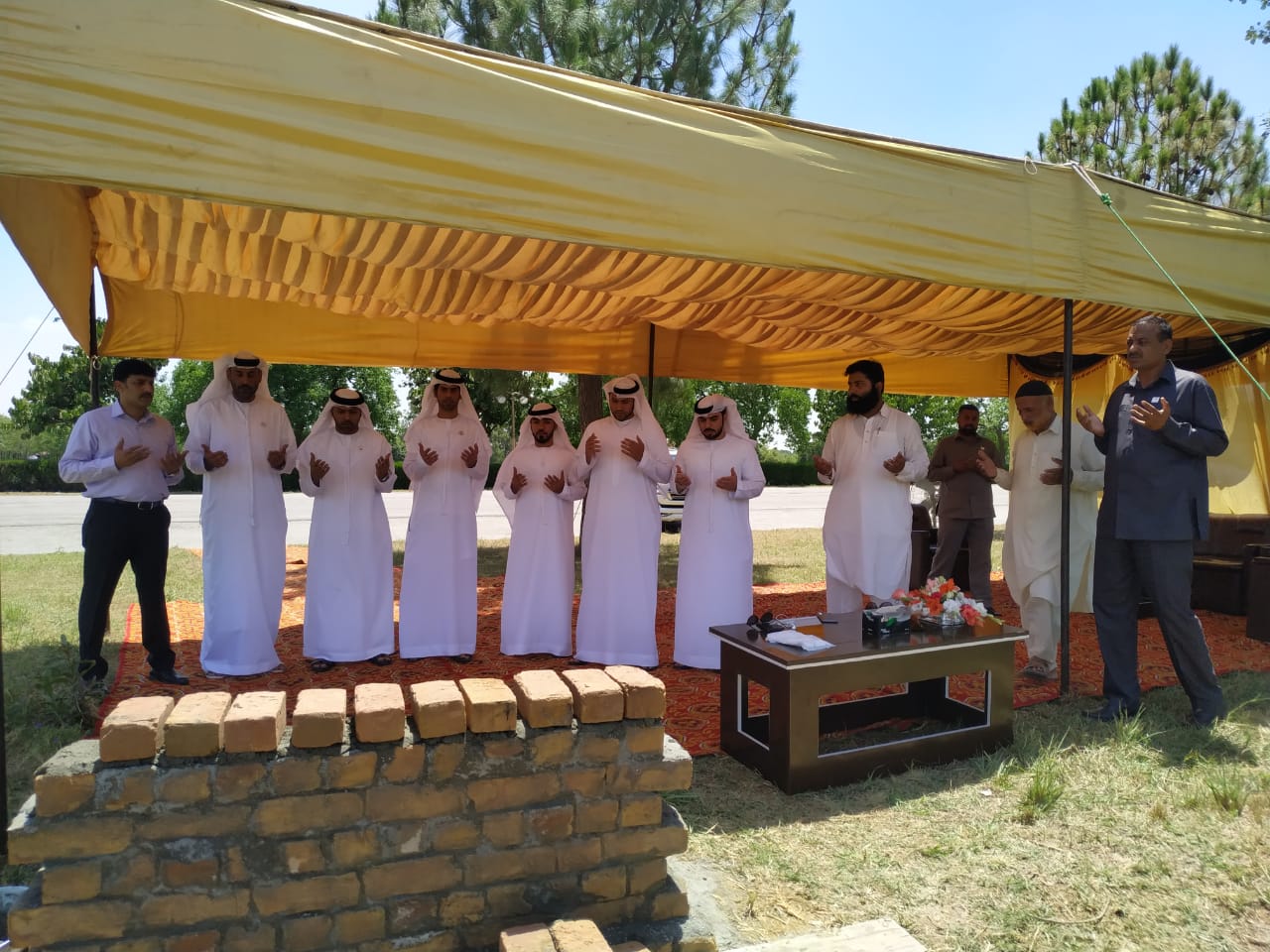 Representatives of the UAE embassy are reciting a prayer on June 13, 2019 after laying the foundation stone of the first mosque inside Islamabad’s largest public park. (Photo Courtesy: UAE Embassy Islamabad)
