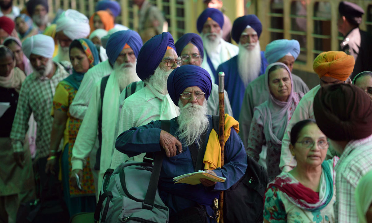 In this undated file photo, Indian Sikh pilgrims arrive at Wagah Railway Station in Wagah, Pakistan, to celebrate Baisakhi, or the Sikh New Year. (AFP)