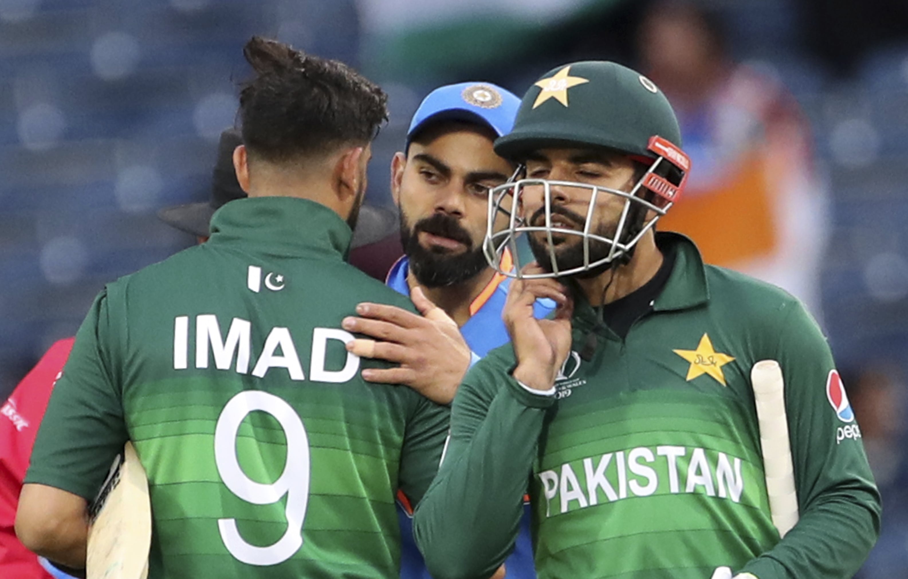 India’s captain Virat Kohli, center, greets Pakistan players at the end of the Cricket World Cup match between India and Pakistan at Old Trafford in Manchester, England, Sunday, June 16, 2019. (AP)