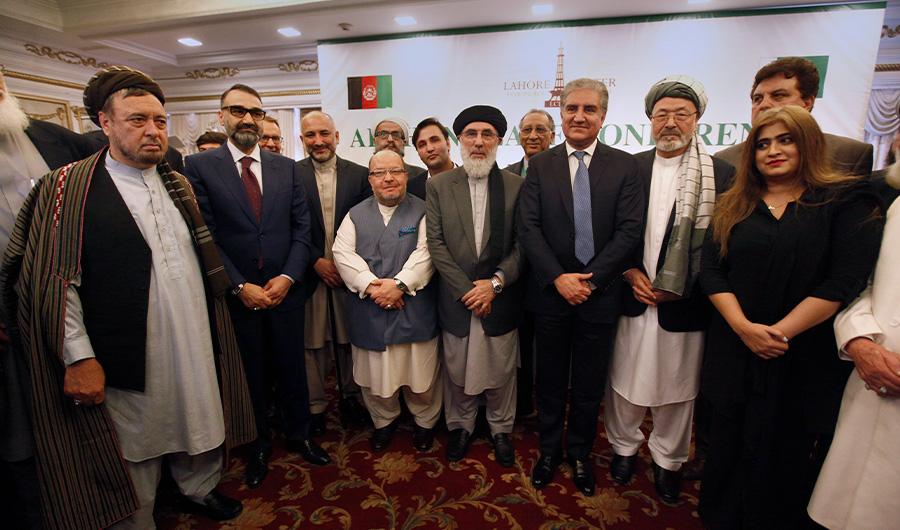 Afghan politicians and other participants pose for a photograph with Pakistani Foreign Minister Shah Mahmood Qureshi, fourth right, after the opening session of an Afghan Peace Conference in Bhurban, 65 kilometers (40 miles) north of Islamabad, Pakistan, Saturday, June 22, 2019. Dozens of Afghan political leaders attended a peace conference in neighboring Pakistan on Saturday to pave the way for further Afghan-to-Afghan dialogue. (AP)