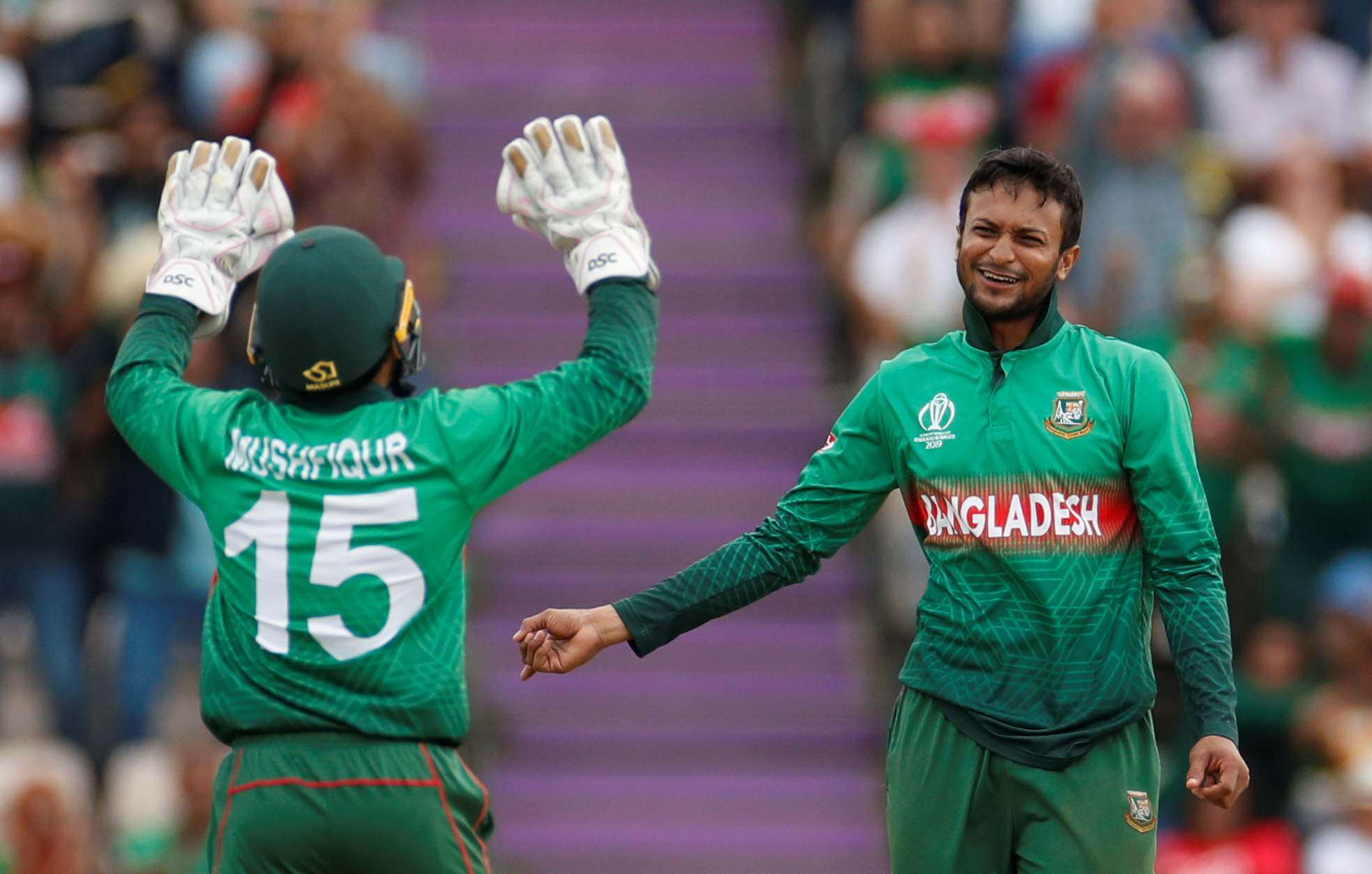 Bangladesh’s Shakib Al Hasan and Mushfiqur Rahim celebrate taking the wicket of Afghanistan’s Najibullah Zadran in the ICC Cricket World Cup match at The Ageas Bowl, Southampton, Britain, on June 24, 2019. (Reuters)