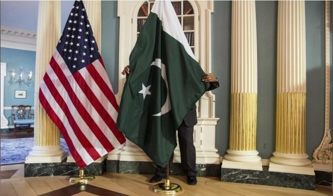 A US State Department contractor adjusts a Pakistan national flag before a meeting between US Secretary of State John Kerry and Pakistan's Interior Minister Chaudhry Nisar Ali Khan on the sidelines of the White House Summit on Countering Violent Extremism at the State Department in Washington on February 19, 2015. (REUTERS)