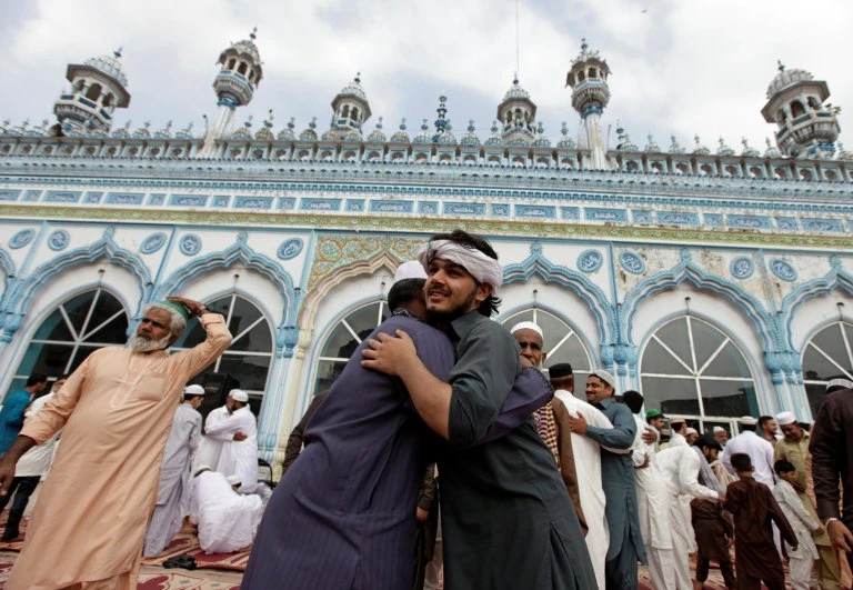 In this file photo people exchange greetings after offering Eid prayers in one of the mosques in Pakistan. The government of northwestern Khyber Pakhtunkhwa (KP) province has announced to observe Eid Al-Fitr today (Tuesday), leading the country to celebrate two Eids. The central government has announced to observe Eid on Wednesday. ( Reuters/File)