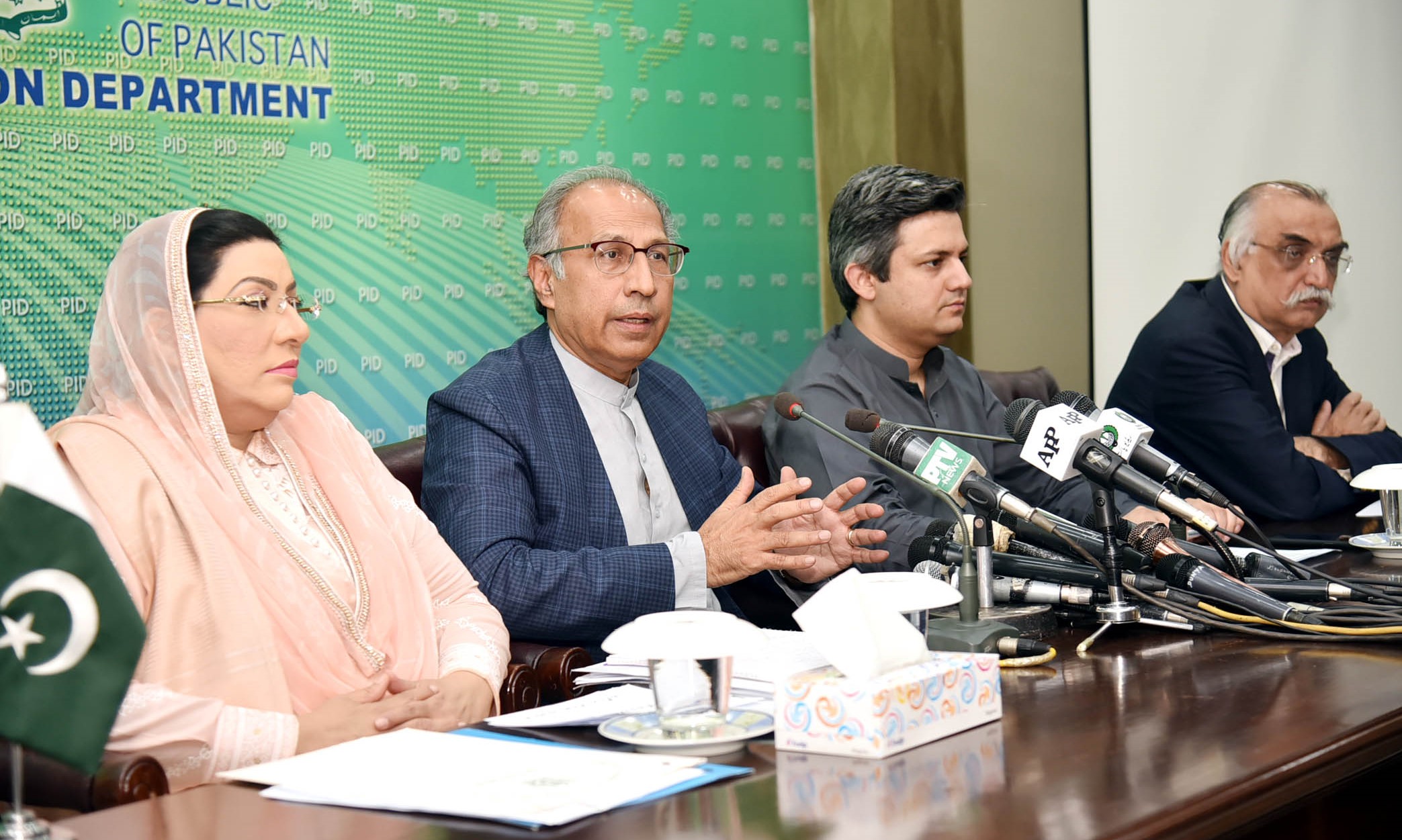 Prime Minister Imran Khan's financial advisor, Abdul Hafeez Shaikh (second from left), along with other officials, addresses a press conference in Islamabad on Sunday. (PID)