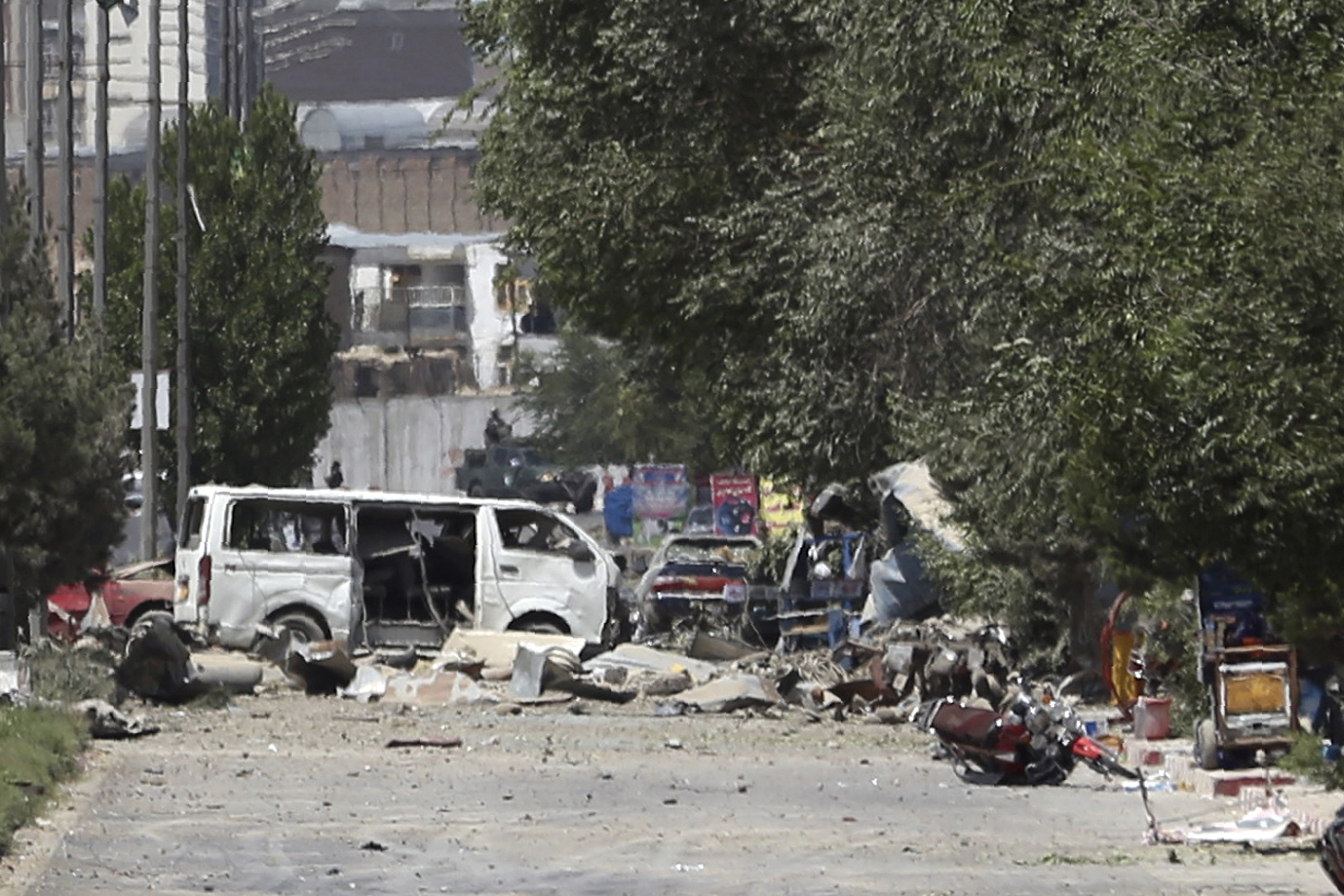 Destroyed vehicles, including a white van, sits at the site of an explosion in Kabul, Afghanistan, Monday, July 1, 2019. A powerful bomb blast rocked the Afghan capital early Monday, rattling windows, sending smoke billowing from Kabul's downtown area and wounding dozens of people. (AP)