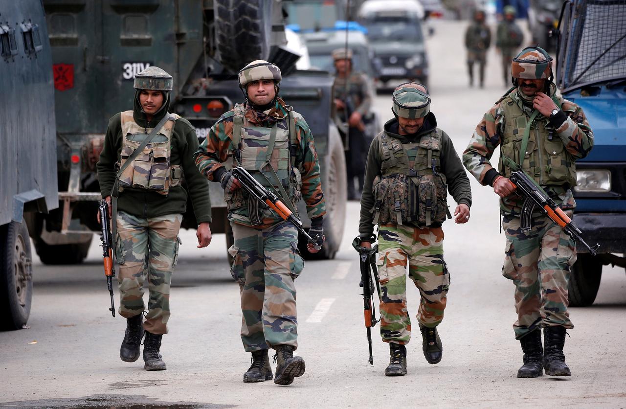 In this April 11, 2018 file photo, Indian army soldiers patrol a street near a site of a gunbattle between Indian security forces and suspected militants in Khudwani village of South Kashmir’s Kulgam district. (Reuters)