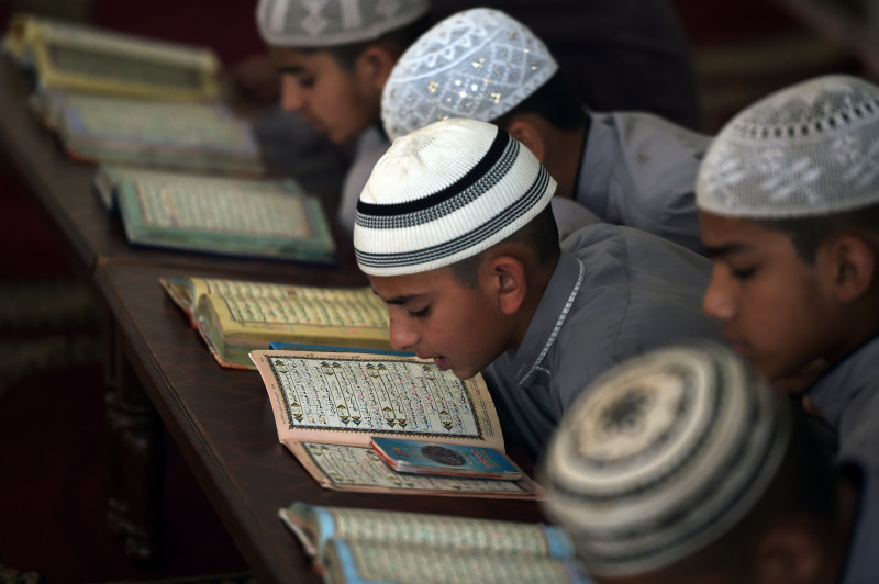 This photograph taken on May 5, 2015 shows Pakistani students of a madrassa or Islamic school recite the Qur’an at their seminary in Islamabad. (AFP)