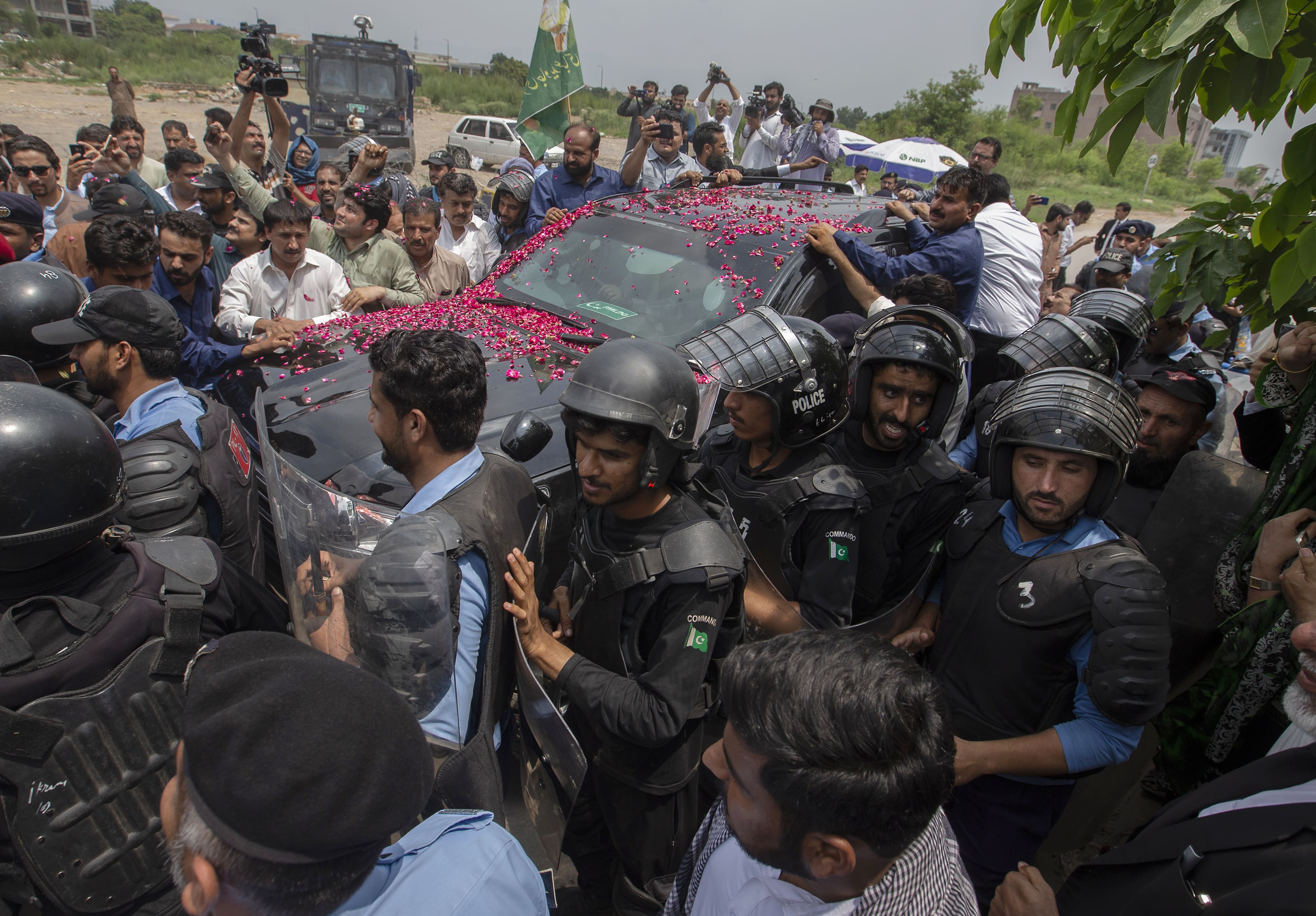 Police officers escort vehicle of Maryam Nawaz, daughter of arrested former premier Nawaz Sharif, to appears in an accountability court in Islamabad, Pakistan, July 19, 2019. Pakistani authorities have also arrested the former prime minister Shahid Khaqan Abbasi and are planning to move against the country’s ex-finance minister Miftah Ismail in a corruption reference. (AP)