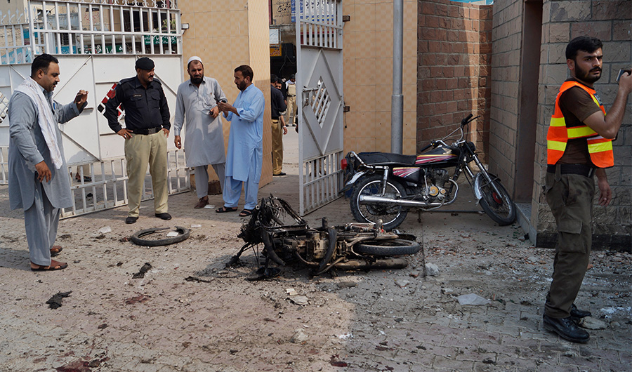 Pakistani security officials examine the site of a bombing on an entrance of a hospital in Dera Ismail Khan, Pakistan, Sunday, July 21, 2019. Police in Pakistan say gunmen opened fire on a police post and then bombed the entrance to a hospital as the wounded were being brought in.(AP)