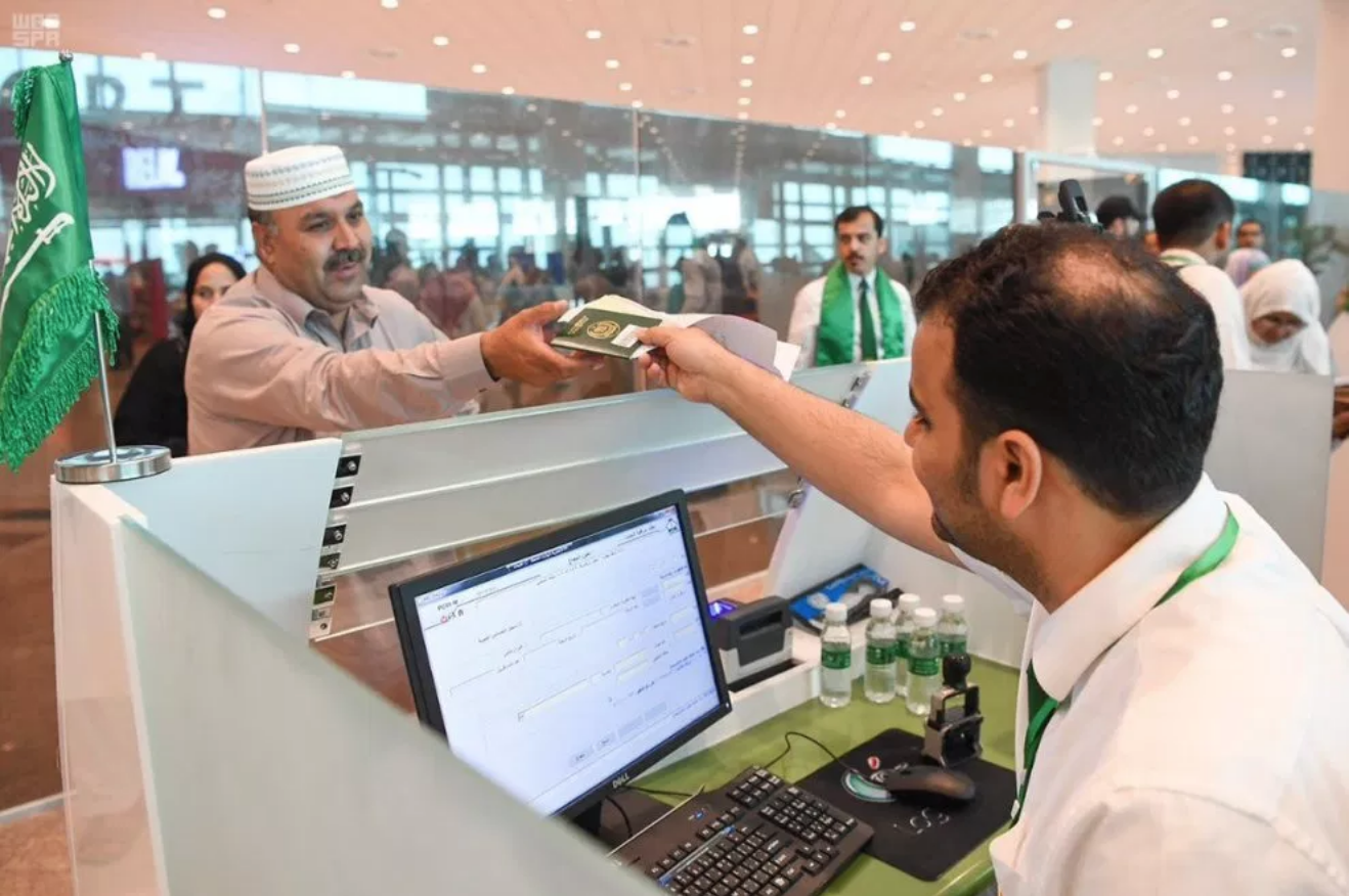 First Hajj flight under Road to Makkah initiative from Islamabad airport left on July 04, 2019. A member of immigration staff checking travel documents for Hajj pilgrims. The Saudi team installed a pre-immigration system at the airport to facilitate Pakistani travelers flying to holy cities Makkah and Madinah this year. (Courtesy: Pakistan Aviation official webpage)