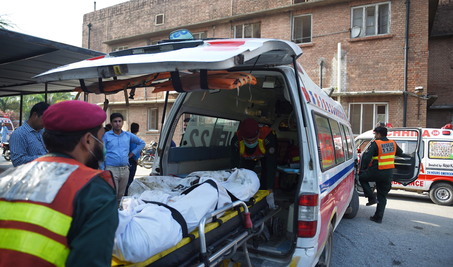 The body of a victim, killed after a Pakistani Army Aviation Corps aircraft crashed into a residential area, is wheeled to a waiting ambulance at a hospital to be taken for DNA identification in Rawalpindi on July 30, 2019. (AFP)