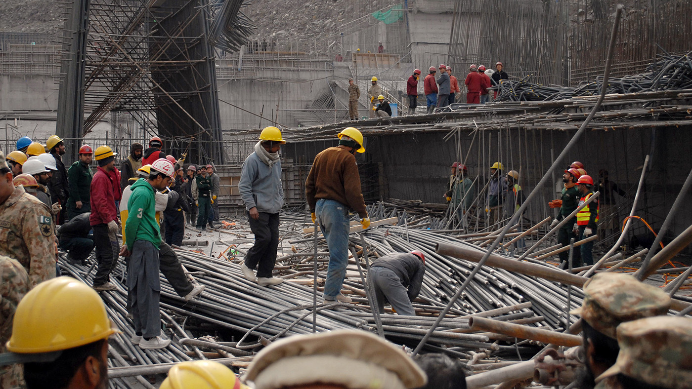 In this file photo, Pakistani workers and Chinese engineers search the site after an accident at the Neelum-Jhelum Hydropower project intake site, some 40 kilometers north of Muzaffarabad on Dec. 24, 2014. (AFP)