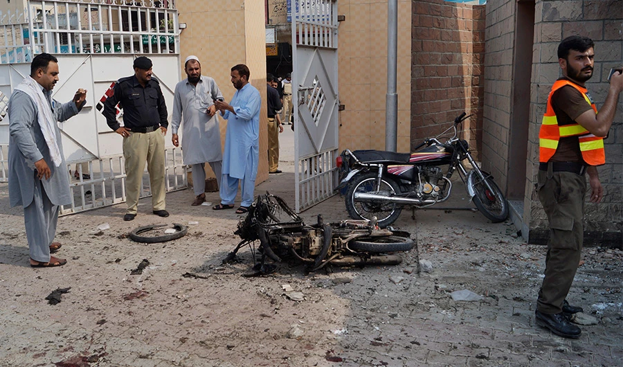 Pakistani security officials examine the site of a bombing on an entrance of a hospital in Dera Ismail Khan, Pakistan, Sunday, July 21, 2019. Police in Pakistan say gunmen opened fire on a police post and then bombed the entrance to a hospital as the wounded were being brought in.(AP)