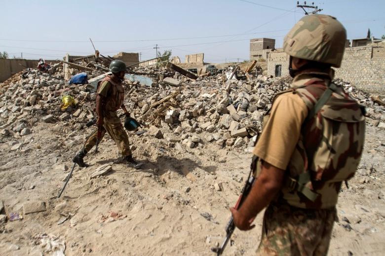 Pakistani soldiers stand near the debris of a house which was destroyed during a military operation against Taliban militants in the town of Miranshah in North Waziristan July 9, 2014. (Reuters)