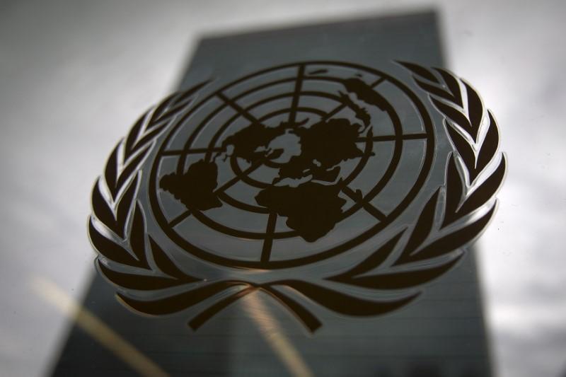 The United Nations headquarters building is pictured though a window with the UN logo in the foreground in the Manhattan borough of New York August 15, 2014. (Reuters)