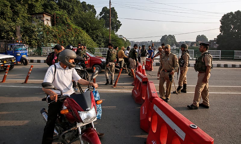 India's security personnel stop people during restrictions in Srinagar on Monday, August 5 - Reuters