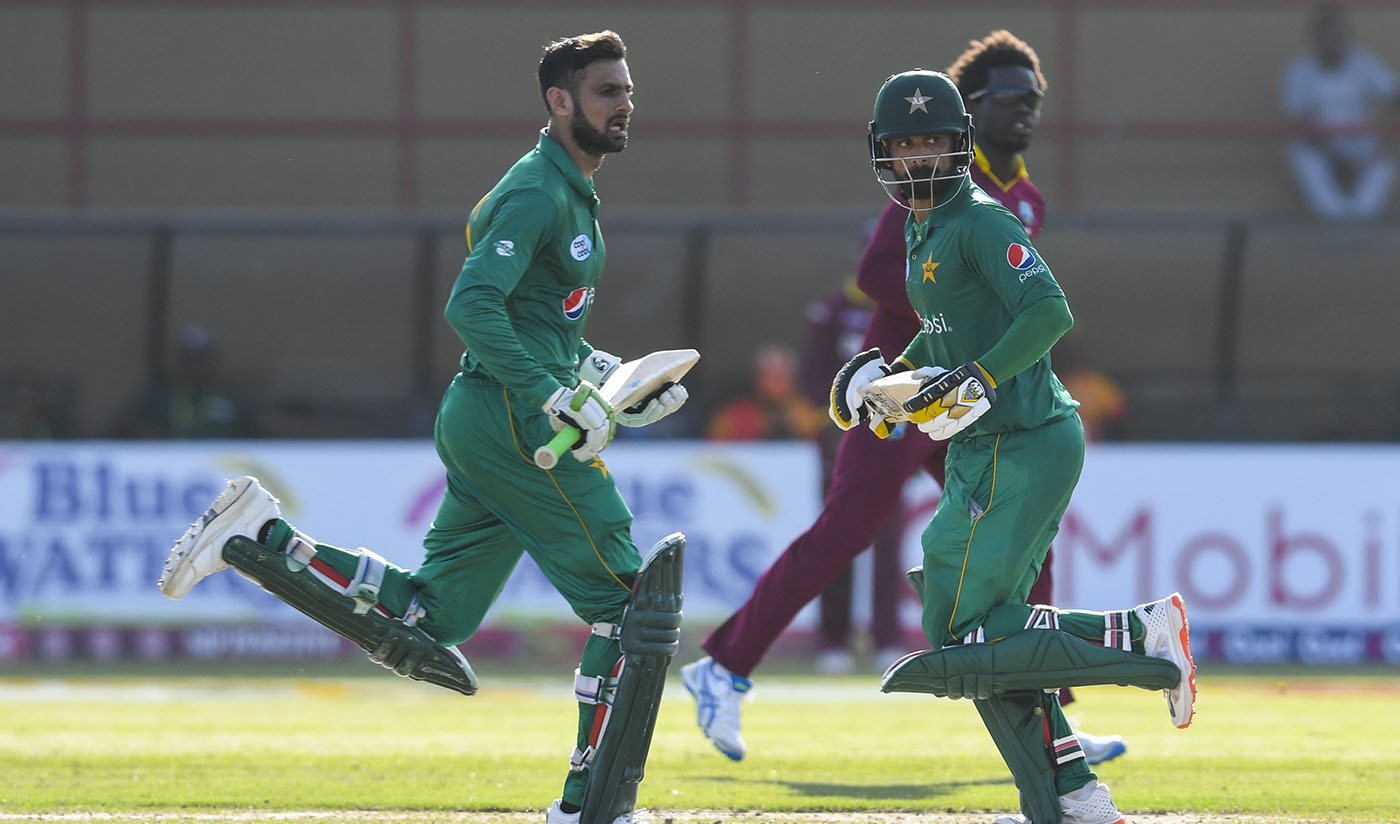 Shoaib Malik, left, and Mohammad Hafeez, center, run during the 3rd and final ODI match between West Indies and Pakistan at Guyana National Stadium, Providence, Guyana, April 11, 2017. (AFP)