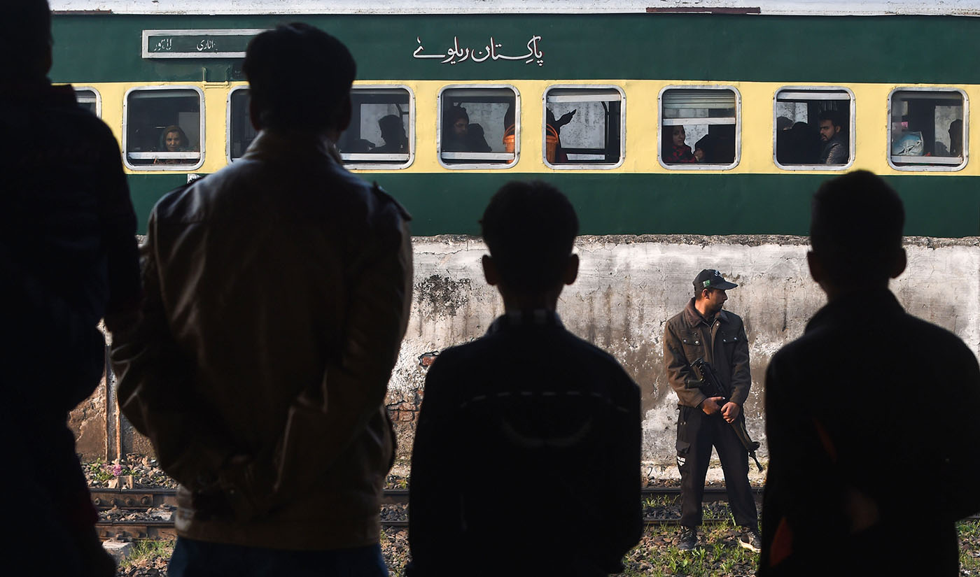 In this file photo, a Pakistani policeman stands guard near the Samjhota Express train traveling to India at Lahore railway station on Feb. 25, 2019. (AFP)