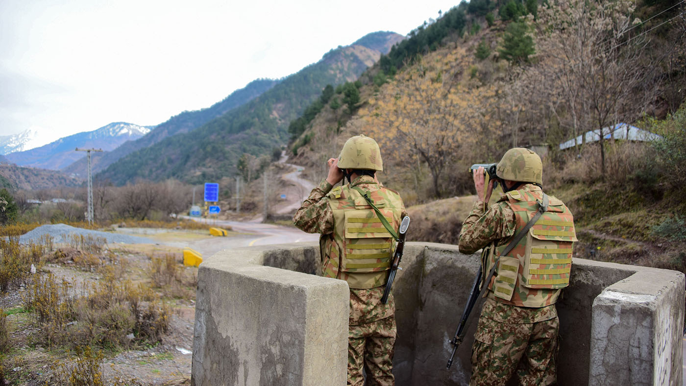 Pakistani soldiers watch over potential Indian troop movements with binoculars in a bunker at the Chakothi post, some 52 kms from Muzaffarabad near Pakistan-India border on Feb. 23, 2019. (AFP)