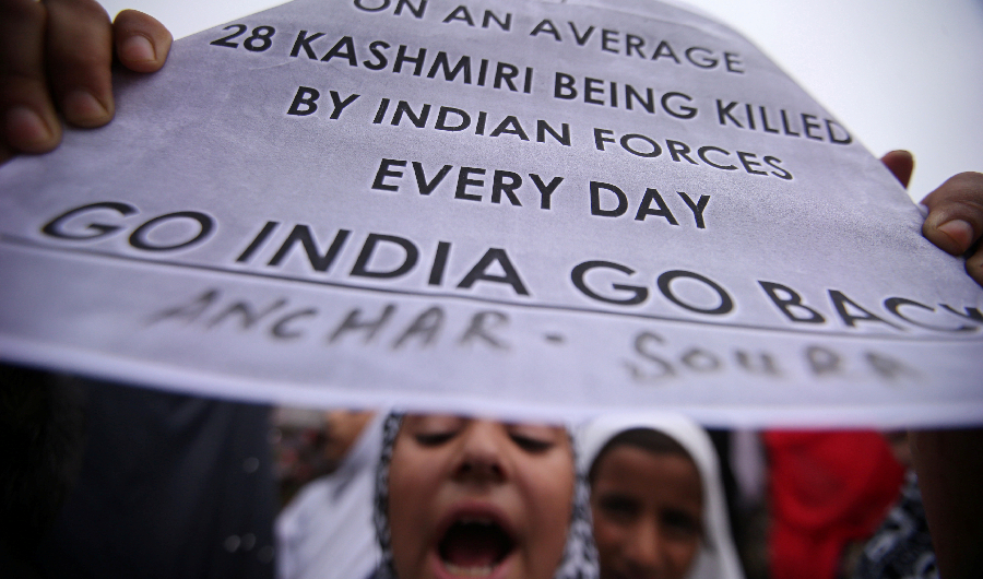 A Kashmiri girl displays a placard as she shouts slogans at a protest after Friday prayers during restrictions after the Indian government scrapped the special constitutional status for Kashmir, in Srinagar August 16, 2019. (Reuters)