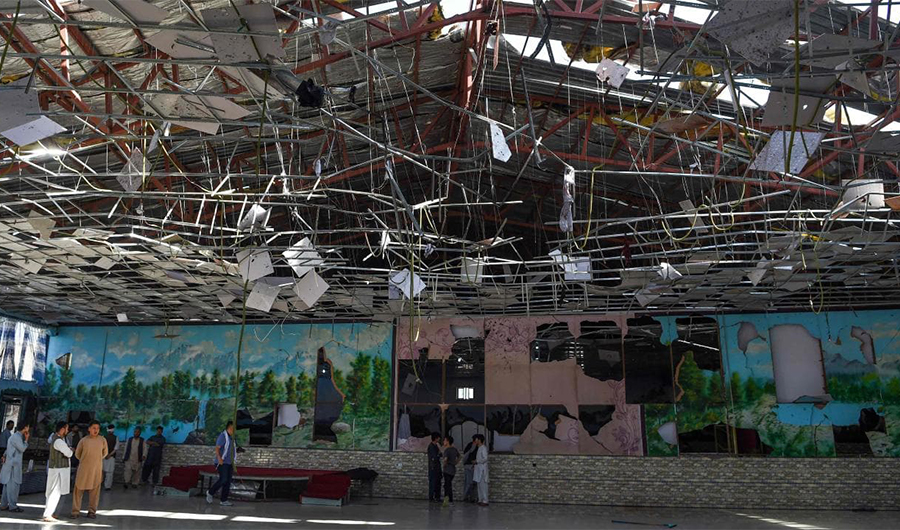 Afghan men inside a damaged wedding hall after a blast in Kabul, Afghanistan August 18, 2019. (Photo Courtesy: AFP)