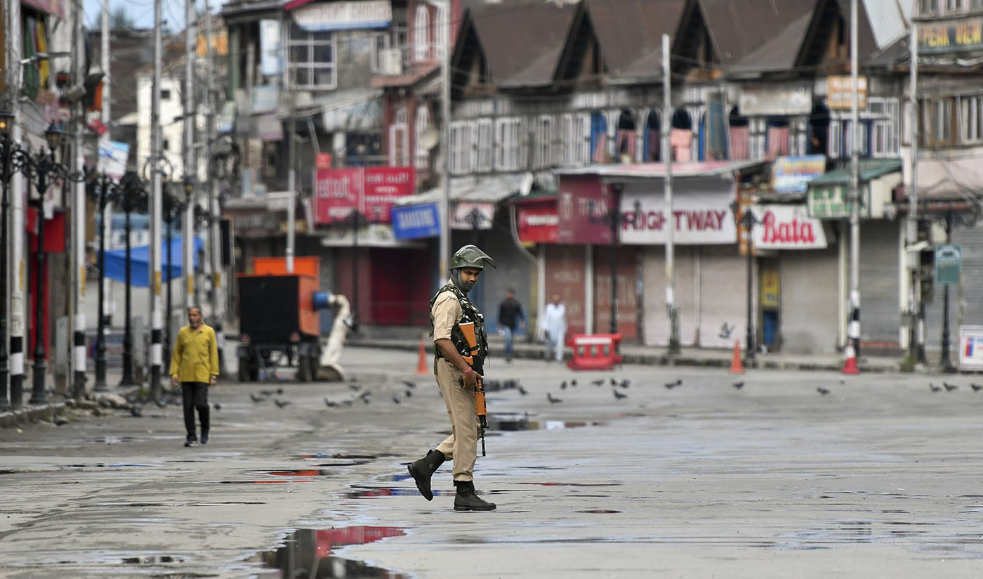 In this file photo taken on August 19, 2019, a security personnel patrols on a deserted road of the Lal Chowk area in Srinagar. (AFP)
