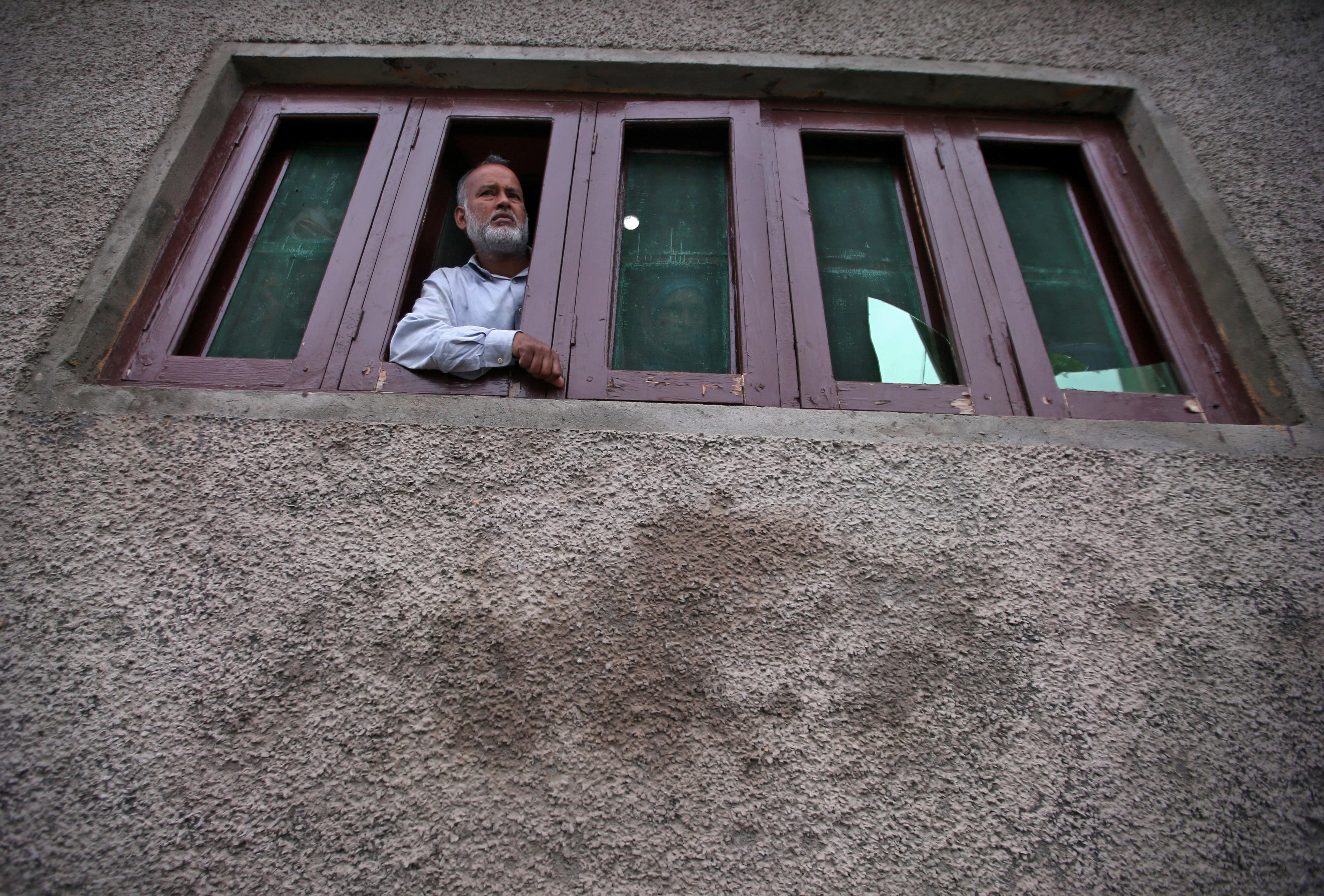 A Kashmiri man looks out from a window of his house which was allegedly damaged by Indian security forces after clashes between protesters and the security forces on Friday evening, during restrictions after the scrapping of the special constitutional status for Kashmir by the Indian government, in Srinagar August 17, 2019. (Reuters)