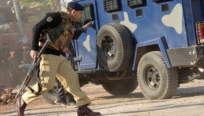 In this file photo a security personnel take position outside an Agriculture Training Institute after an attack by terrorists in Peshawar. (AFP)